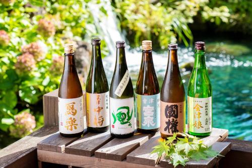 a group of bottles of wine sitting on a wooden table at Harataki in Aizuwakamatsu