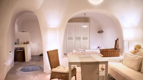 un salon avec une table et un canapé dans l'établissement Oia, Finikia Cave House, à Oia