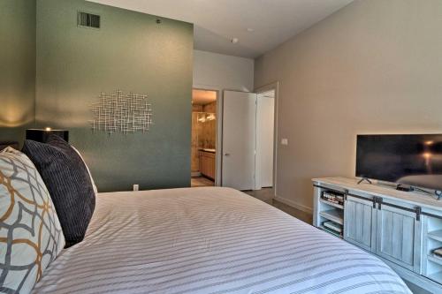 a bedroom with a bed and a flat screen tv at Urban Escape in SoLA with Private Patio! in Austin