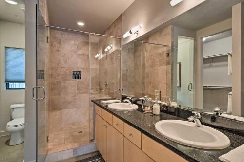 a bathroom with two sinks and a shower at Urban Escape in SoLA with Private Patio! in Austin