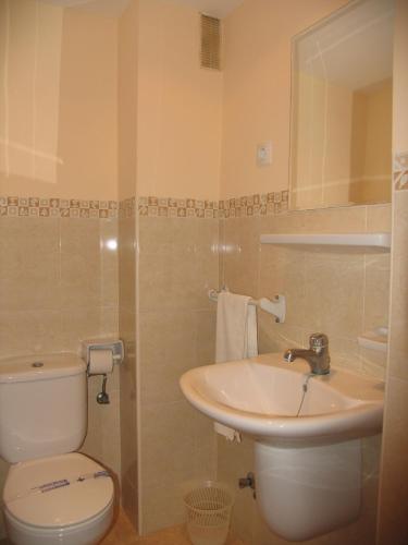 a bathroom with a toilet and a sink at Apartamentos Tesy in La Manga del Mar Menor