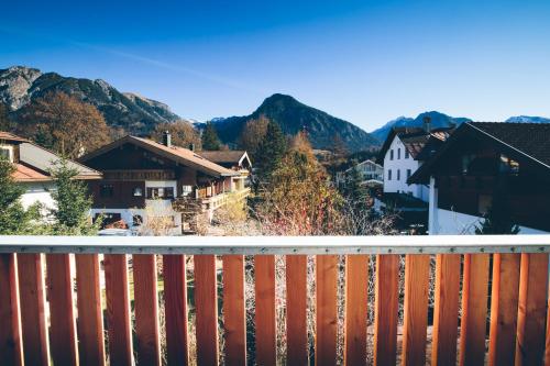 a view from the balcony of a town with mountains at Apartmenthotel Oberstdorf in Oberstdorf