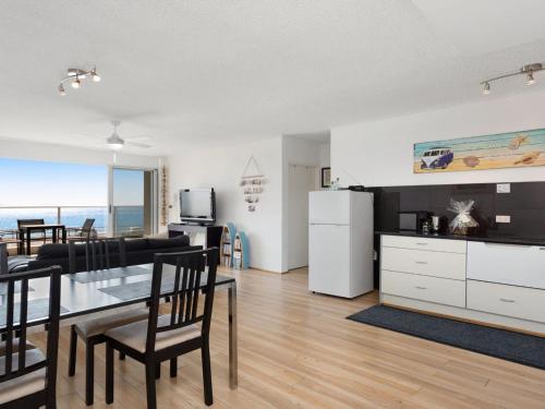 a living room with a kitchen and a dining room at Oceanic 2 On Main Beach in Forster