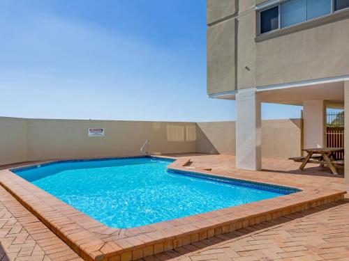 a swimming pool in front of a building at Oceanic 2 On Main Beach in Forster
