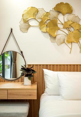 a bedroom with a mirror and a bed at Ann Hotel & Spa Khem Beach PQ in Phú Quốc