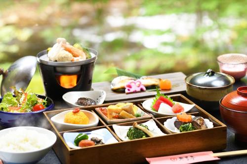 a table with a tray of food on a table at Konjakutei in Aizuwakamatsu