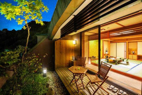 a balcony of a house with a table and chairs at Konjakutei in Aizuwakamatsu