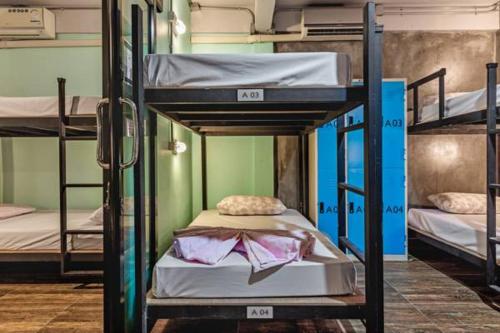 a room with three bunk beds in a dorm at The Guest Hotel Krabi in Krabi town