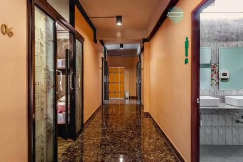 a corridor of a bathroom with two sinks at The Guest Hotel Krabi in Krabi town