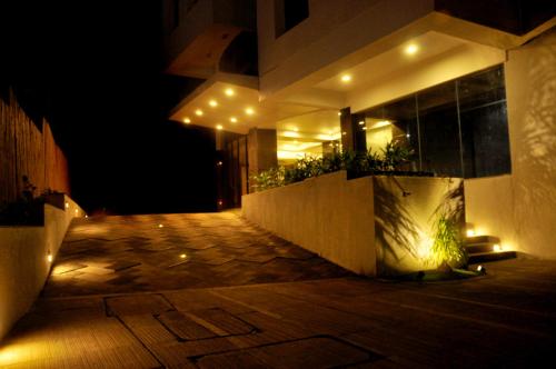 a night view of a building with lights on it at Hotel Solitaire in Pune