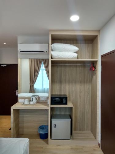 a room with two bunk beds and a window at Maple Boutique Hotel in Melaka