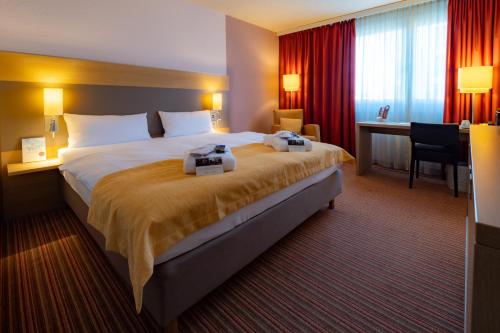 Кровать или кровати в номере The Rilano Hotel Stuttgart Böblingen