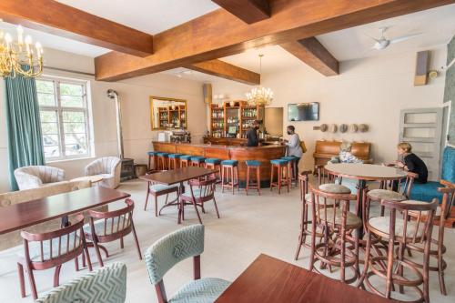 a restaurant with tables and chairs and a bar at Montagu Country Hotel in Montagu