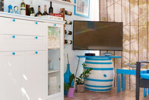 a living room with a flat screen tv on a wall at Apartments Neppa in Postira