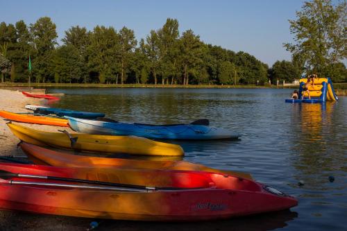 a group of kayaks on the shore of a lake at Whaka Lodge in Seissan