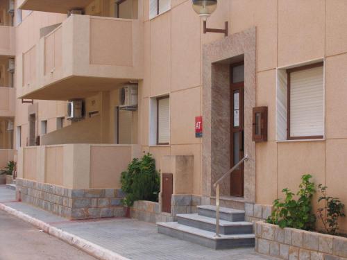 a building with stairs on the side of it at Apartamentos Tesy in La Manga del Mar Menor