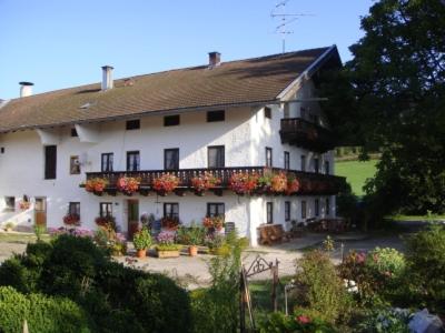 a large white house with flowers in front of it at Maierhof in Chieming