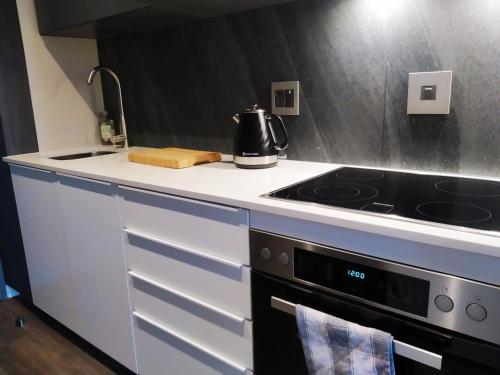 a kitchen with a stove and a sink at The Residence Luxury Studio - Menlyn Maine in Pretoria