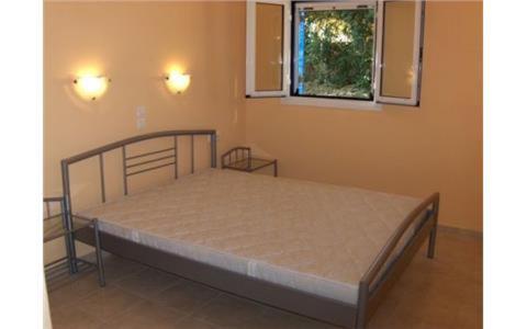 a bedroom with a bed in a room with a window at Theodora Studios in Yenion