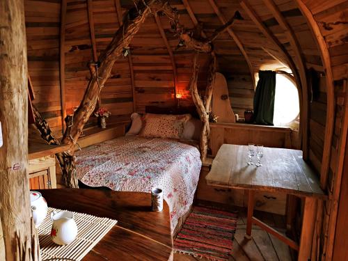 1 dormitorio en una cabaña de madera con 1 cama y 1 mesa en HOBLEY House Holiday en Craven Arms