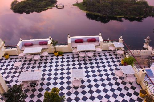 an aerial view of a patio with tables and chairs at Hotel Mewari Villa PURE VEG in Udaipur