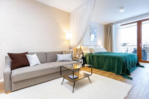 a living room with a couch and a bed at Apartman Lucid C207 in Smokovce