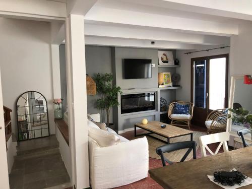 a living room with a couch and a table at Big family house in the Center of el port de la selva in Port de la Selva