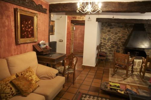 a living room with a couch and a fireplace at Casona de San Pantaleón de Aras in San Pantaleón de Aras