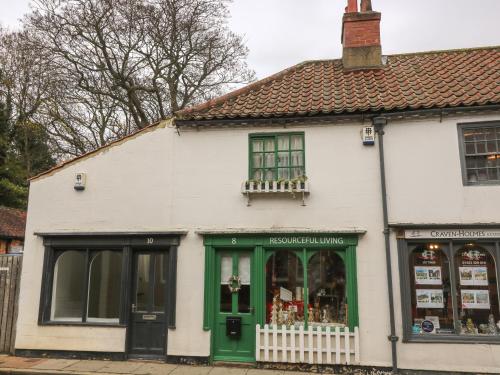 a white building with a green door at The Hideaway in York