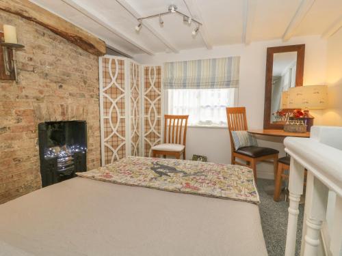 a room with a bed and two chairs and a fireplace at The Hideaway in York