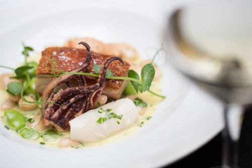 a white plate of food with meat and vegetables at The Chester Grosvenor in Chester