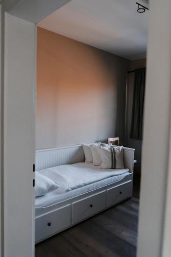 a bed with white sheets and pillows in a room at Stupperhof in Kitzeck im Sausal