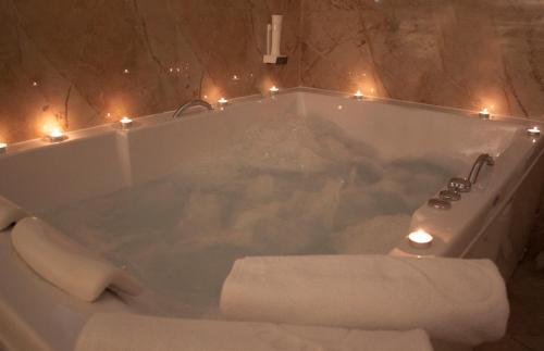 a bathroom with a tub with lights in it at Agropolog Hotel & Spa in Želino