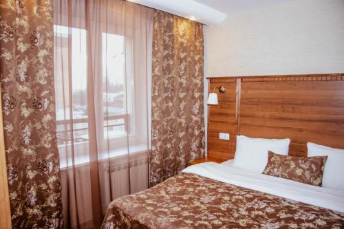 a hotel room with a bed and a window at Kievskaya Hotel in Saint Petersburg