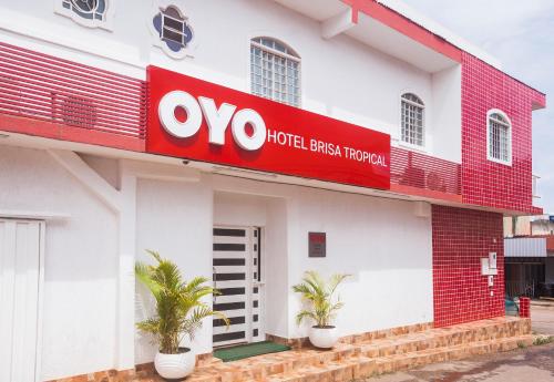 a hotel with a red sign on the side of a building at OYO Hotel Brisa Tropical, Brasília in Brasilia
