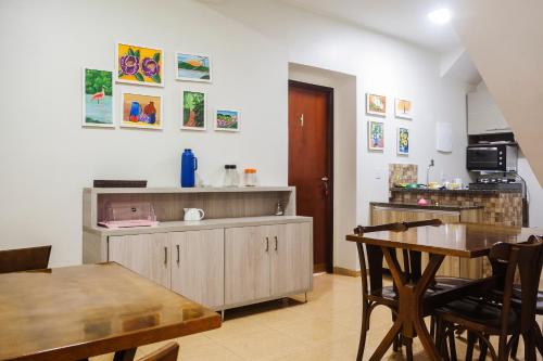 a kitchen with a table and a dining room at OYO Hotel Brisa Tropical, Brasília in Brasília