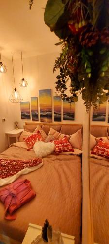 a bedroom with a bed with pillows on it at Brīvdienu māja ar Saunu in Saulkrasti
