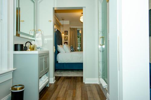 a bathroom with a bedroom with a bed in it at The Colonial Inn in Hillsborough