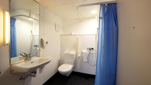 a bathroom with a sink and a toilet and a shower at Solothurn Youth Hostel in Solothurn