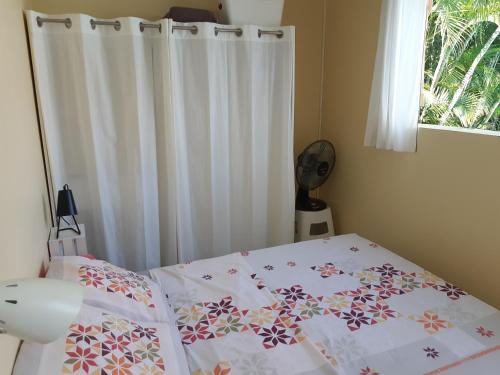 a bedroom with a bed with a white curtain and a window at KazTiFahamAimée in Saint-Louis