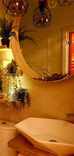 a bathroom with a white tub and a mirror at Brīvdienu māja ar Saunu in Saulkrasti