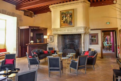 a living room with chairs and a fireplace at Hôtel Golf Château de Chailly in Chailly-sur-Armançon