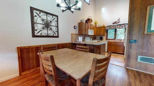 a large kitchen with a wooden table and chairs at Meadow Ridge #28 condo in Mammoth Lakes