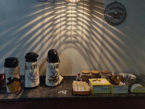 a table with food and condiments on it at Pousada avenida in Urubici