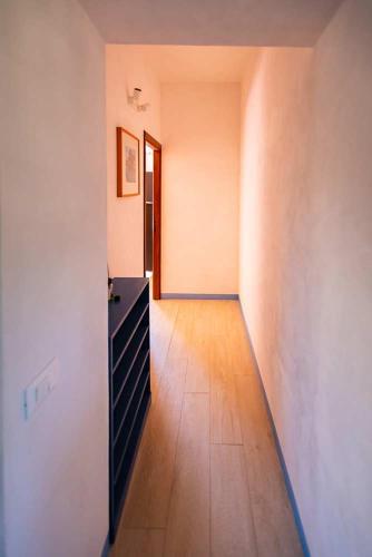 an empty room with a dresser and a hallway at Appartamento Villa Matone in Grottaferrata