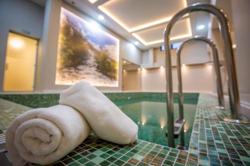 a towel sitting on top of a bathroom sink at SREBRNA PLANINA Spa & Resort in Kopaonik