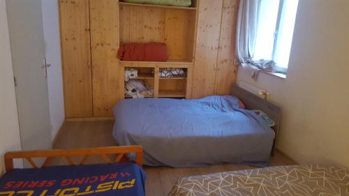 a small room with two beds and a window at maison bleue in Belfort