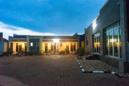 a building with a brick driveway in front of it at AVISHA TOWN HOTEL in Kigali