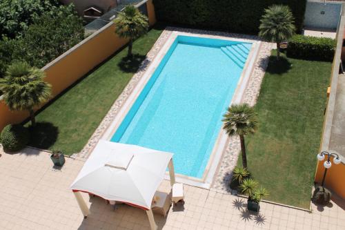 an overhead view of a swimming pool with a table and an umbrella at Hotel Grillo in Assemini