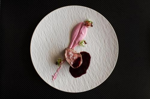 a white plate with a piece of food on it at Hotel Hirzer 2781 in Avelengo